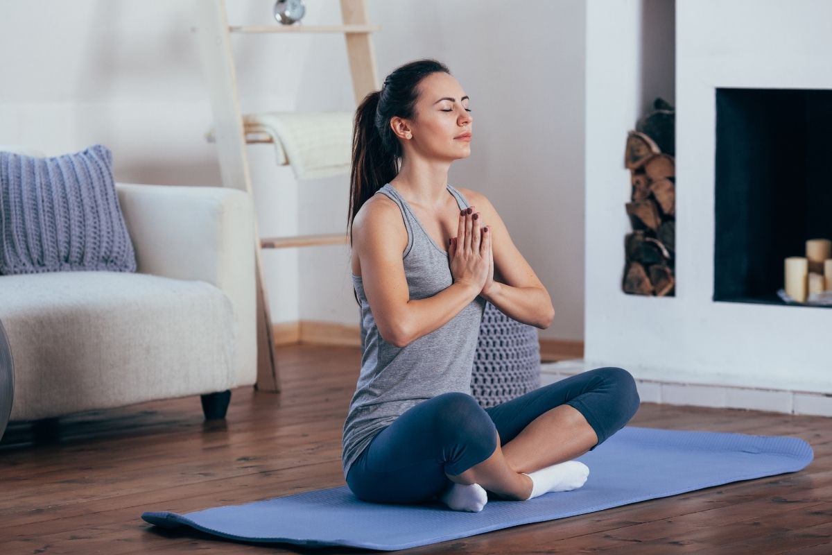 A woman does a yoga post as a form of addiction therapy.