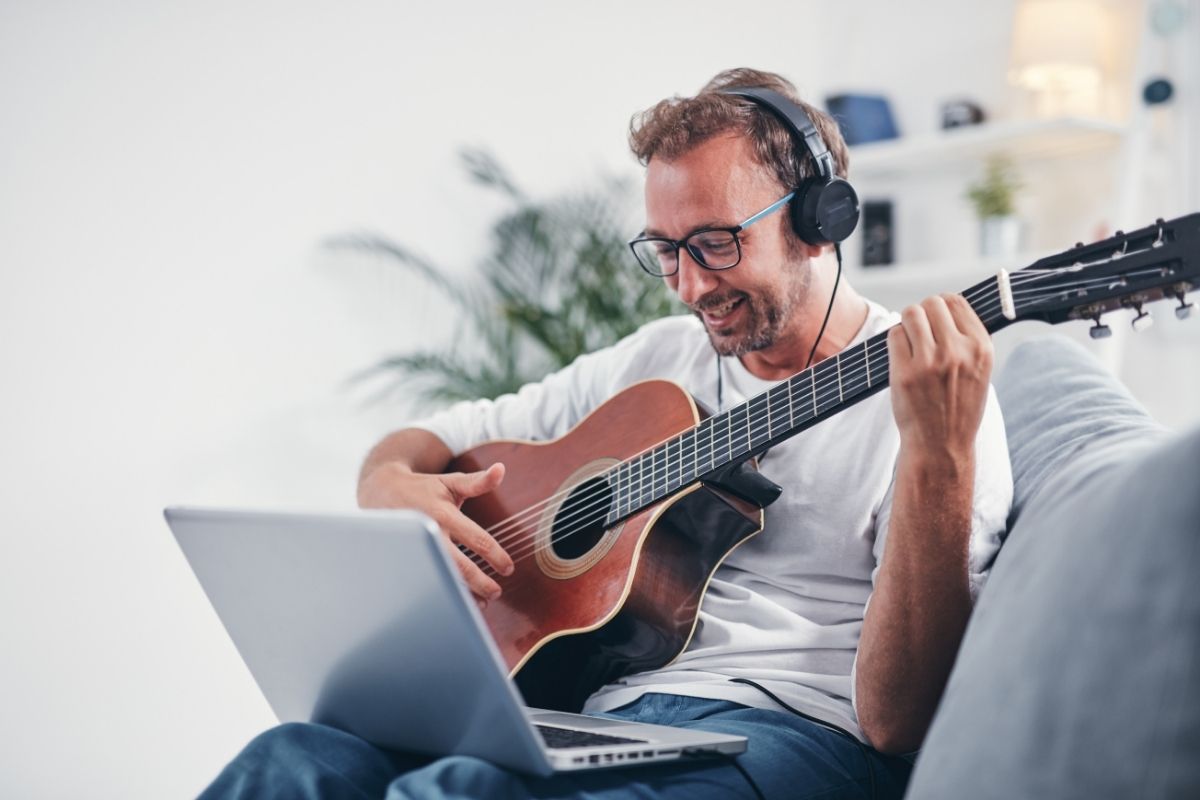 A man plays the guitar and learns a new hobby through music therapy.