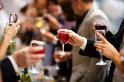 Raising a glass to toast at a holiday party