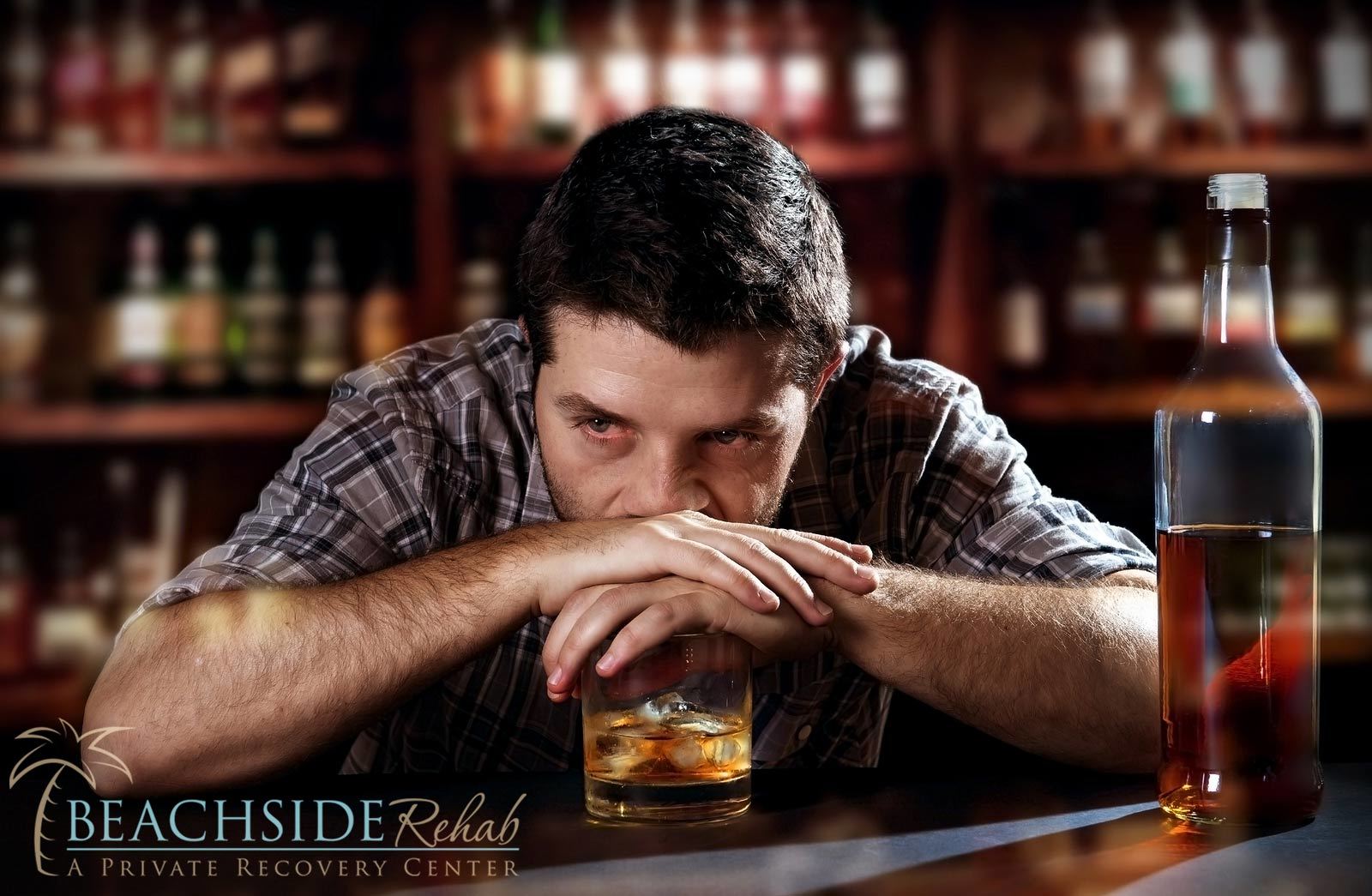 man sitting with drink in hand