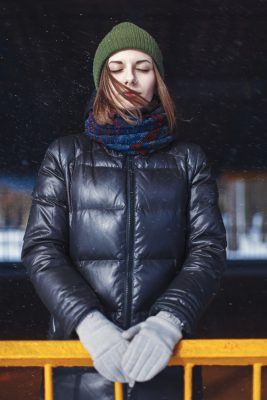 woman closing her eyes in the snow