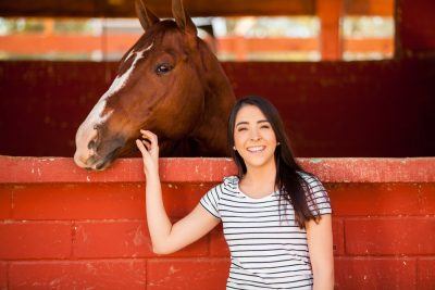 woman standing with horse for equine therapy 