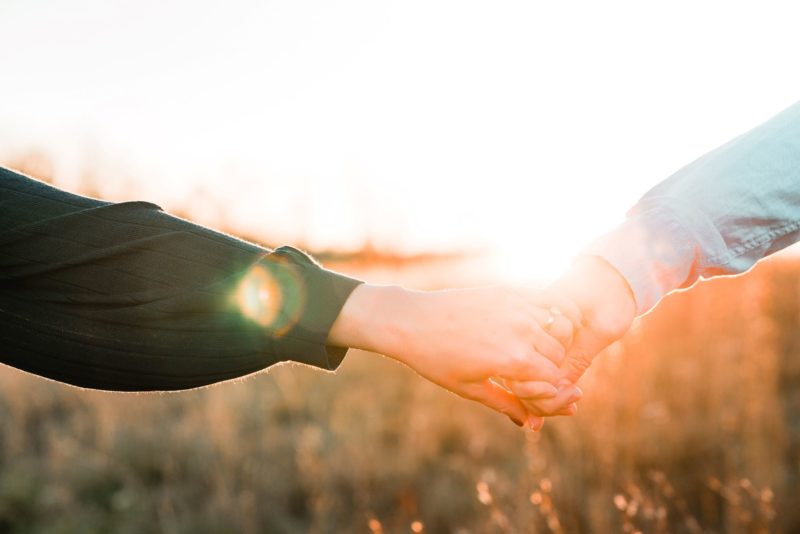 helping a loved one by holding hands