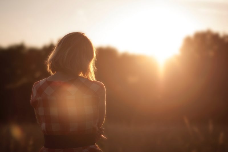 woman looking toward sunset before alcohol rehab