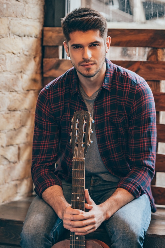 man practices guitar during outpatient rehab treatment man practices guitar during outpatient rehab treatment