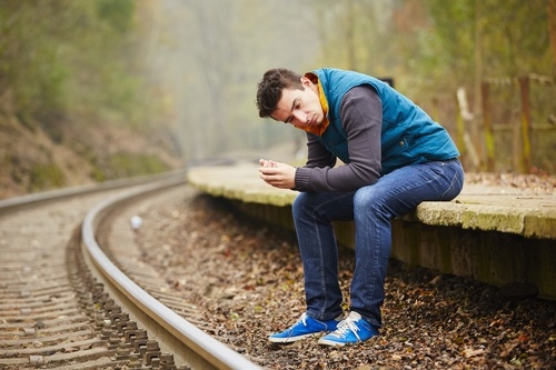 man on railroad tracks figuring out if he needs to go to rehab for crack addicts