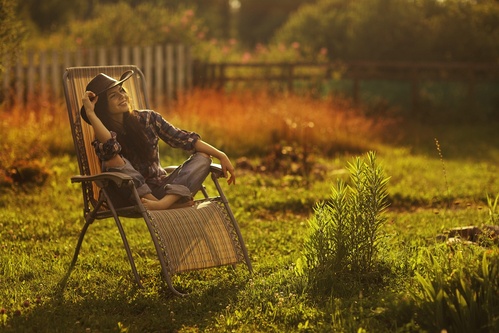 happy woman in chair after completing addiction treatment