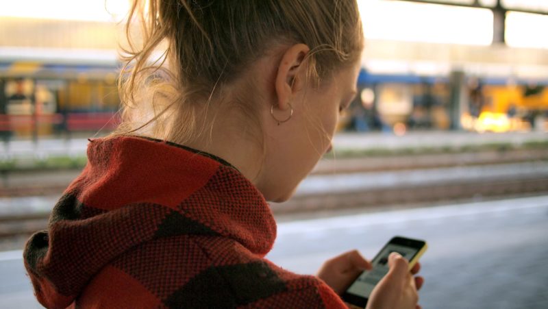 woman looking down on phone