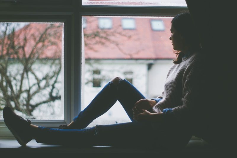 woman staring out window